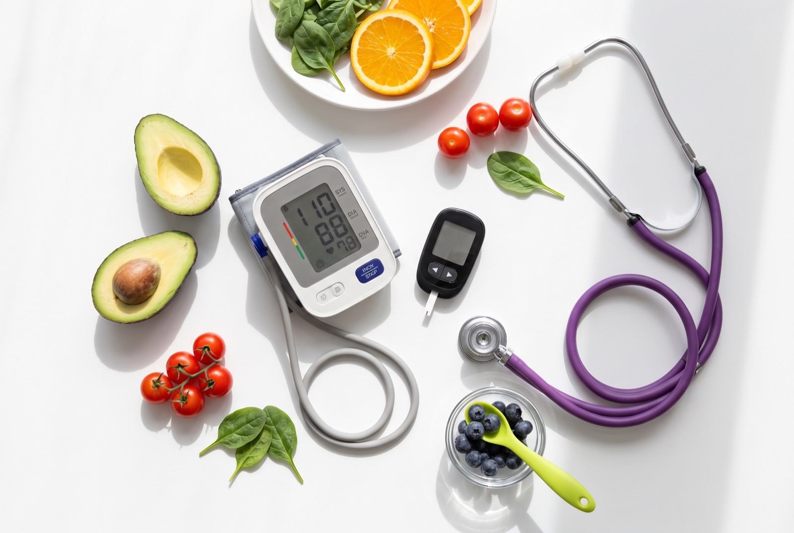 Blood pressure monitor, glucometer, stethoscope and fresh healthy food